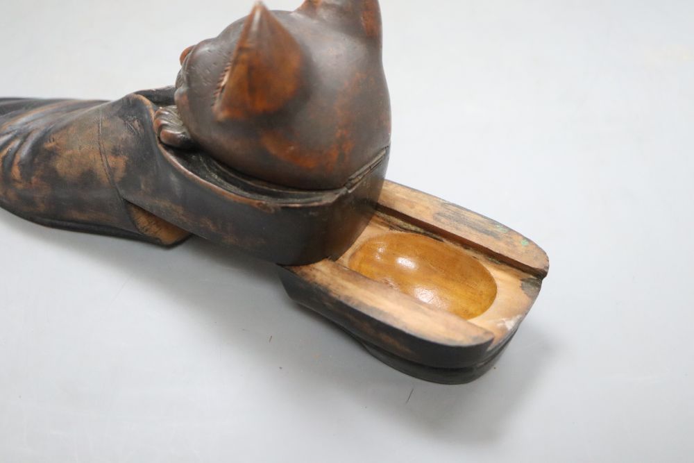 An early 20th century carved wood cat in a shoe inkwell, with hidden compartments, length 20cm